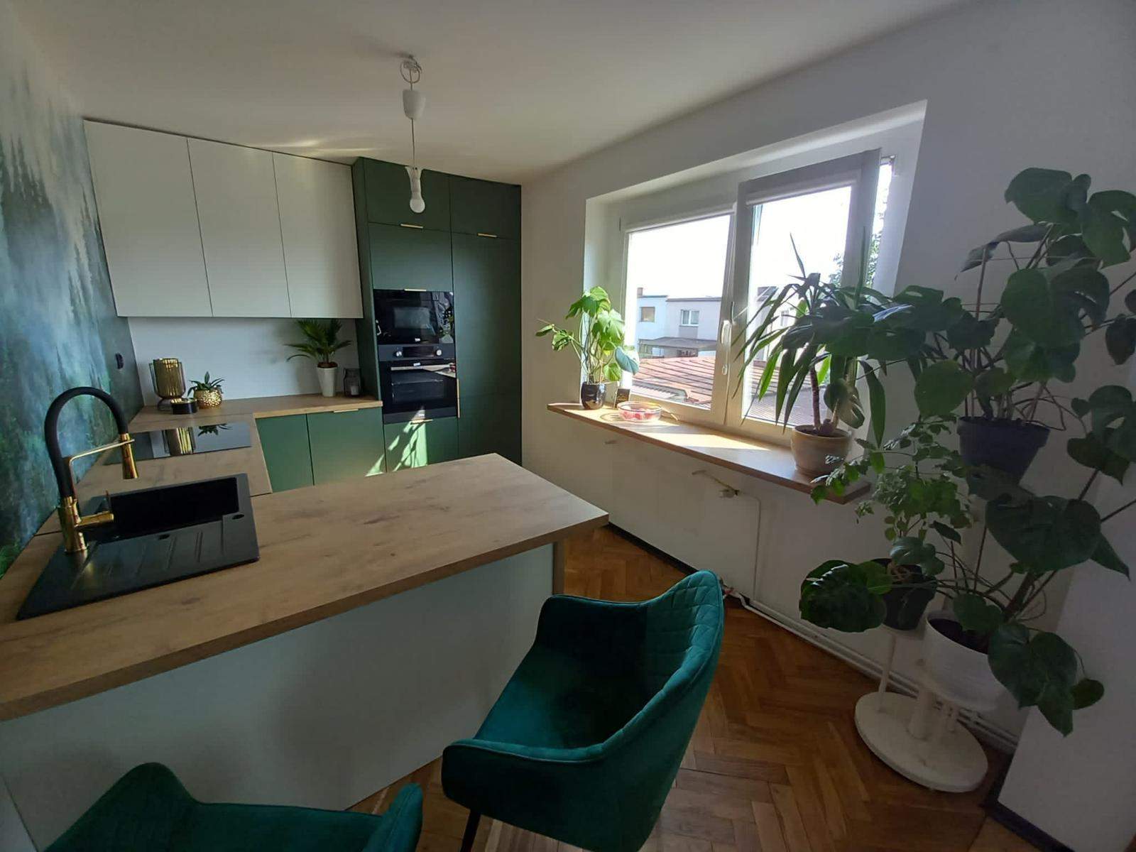 wąska biało zielona kuchnia z wyspą śniadaniową 